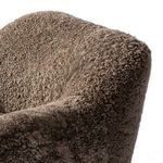 Close-up of top corner of chair backrest showcasing taupe plush shearling texture