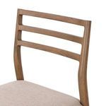 Angled close-up of the wood frame's upper backrest slats and light beige fabric seat edge