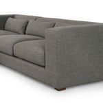 Close-up of right arm and cushions displaying tight fabric weave and supportive padding