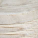 Close-up of hand-carved wooden grooves and texture on stool surface
