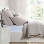 Natural linen sham in muted beige with soft, textured fabric and a plush, airy look on a bed