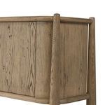 Close-up of rounded wooden leg and frame detail on sideboard corner connecting to paper cord shelf