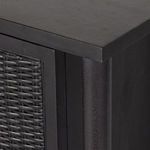 Close-up angled view of woven basket blend cane front drawers and side solid wood panel.