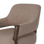 Close-up of Henrik Desk Chair's curved brown woven fabric back and wooden armrest