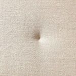 Overhead angled focus on cushion tufting and meeting corner of sectional bench