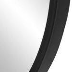 Close-up of black mirror frame edge showing smooth curved corner and matte finish