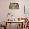 Sable Paper Rope Pendant Light hanging over round white dining table with wood and rattan chairs
