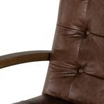 Close-up of chair base with ash wood spokes and black caster wheels.