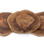 Three round teak trays laid flat overlapping, showing variation in size and wood grain