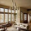 Heritage Sage Navy rug styled under neutral modern sofa and chair in spacious living room with large windows
