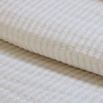Close-up showing the fine woven grid texture and soft cotton fabric of the sham