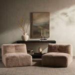Two pewter shaggy accent chairs styled together in a living room setting with wall art and decorative accessories