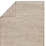 Back side of the rug with corner lifted revealing tightly woven backing and consistent striped pattern