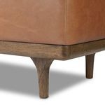 Close-up of trunk's oak frame and tapered leg with wood grain texture
