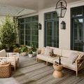 Outdoor patio setting featuring the Saylor Earthen Weave Rug under beige cushioned wooden furniture