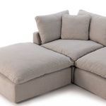 Top view of ottoman and adjoining sectional seat cushions highlighting plush padding and fabric softness