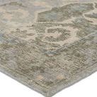 Close-up showing detailed hand-knotted wool texture and scroll pattern in sage and blue hues