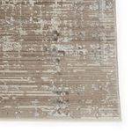 Close-up of rug’s distressed horizontal striped texture in muted gray and tan palette