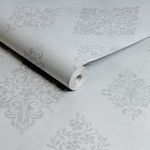 Rolled wallpaper showing side view with repeated diamond motif and slightly textured matte finish