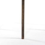 Detail view of the textured dark metal cylindrical leg of the planter stand against a white background