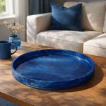 Large blue resin tray displayed on wooden table with sofa and blue cushion in the background