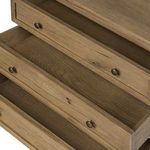 Interior wood of three extended drawers revealing natural grain in storage space