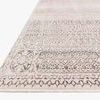 Low angled close-up showing texture and edge detail of ivory and silver vintage style rug
