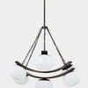 Duxbury Chandelier with six voluminous seedy glass shades suspended from curved dark metal bands and chains