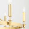 Detailed view showing lit candle-style bulbs and gold floral accents on circular frame