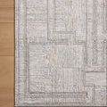 Top-down view of rug corner showing clean bound edges and geometric pattern detail on wood