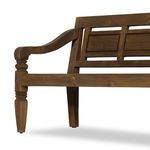 Low-angle shot focusing on front left leg and armrest with visible nail heads and wood texture