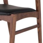 Close-up of seat frame corner showing tapered leg detail and black fitted wool/nylon blend cushion texture