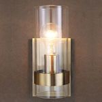 Sconce lit against textured brown wall showing warm light glow and wall mounting