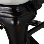 Close-up of black metal seat frame and curved chair leg with slight texture