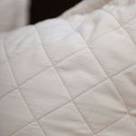Close-up of Monaco coverlet showing diamond quilted pattern and smooth bamboo sateen texture