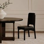 Pair of Kerr dining chairs positioned on either side of wood dining table with decorative vase