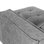 Close-up of opposite armrest corner emphasizing piping detail and fabric texture