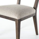 Close-up side angle of Jax Dining Chair showing wood leg joint and upholstery seat edge