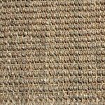 Extreme close-up of hand-woven natural seagrass fibers highlighting texture and weave pattern