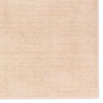 Close-up on subtle luster and texture details in the cream-beige handwoven rug surface