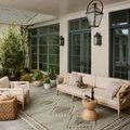 Saylor Granite Veil Rug styled on a covered patio with outdoor seating and plants