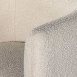 Close-up of armrest corner showing detailed boucle fabric texture and stitching on Adriel chair