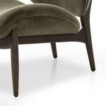 Detail of seat cushion curve with upholstery stitching and wooden frame below