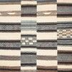 Mika Ivory Multi Rug with abstract tribal patterns in ivory, black, blue, and brown tones, textured yarn detail