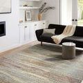 Bowery Pebble / Multi rug styled in bright living room with black sofa and natural decor