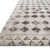 Close-up of another rug with diamond pattern in light beige and dark brown tones