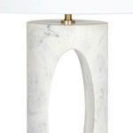 Close-up of top part of marble base highlighting oval cutout and brass detailing