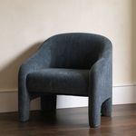 Tuva Accent Chair styled in a room setting on dark wood floor with beige wall backdrop
