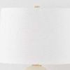Top close-up of the white fabric lamp shade with subtle texture and gold finial