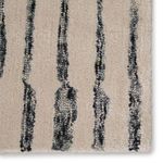 Zoomed-in detail of the rug’s varied stripe texture and color contrast